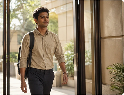 Young professional walking through office entrance